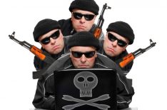 Group of terrorists with laptop and weapons.