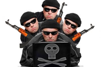 Group of terrorists with laptop and weapons.