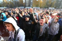 Demonstrators shout nationalist slogans during a protest in Moscow, Russia, Sunday, Oct. 13, 2013. The fatal stabbing of an ethnic Russian man has ignited anger in Moscow against people from the Caucasus, with demonstrators breaking into a shopping center and storming a vegetable warehouse Sunday evening. Police detained hundreds of people. (AP Photo/Mikhail Listopadov)
